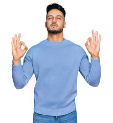 Young arab man wearing casual clothes relax and smiling with eyes closed doing meditation gesture with fingers. yoga concept.