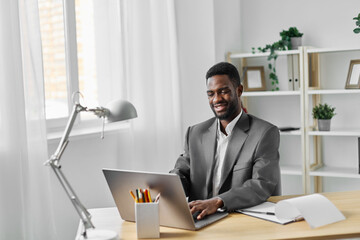 freelancer man office online job laptop computer education student web american african