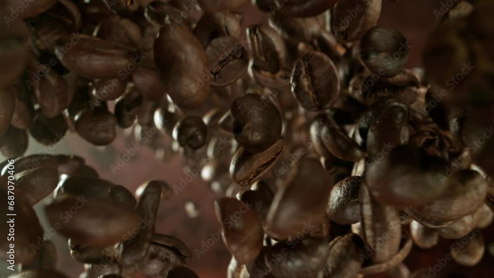 Poster super slow motion of rotating falling coffee beans isolated on brown background. macro shot, smoke o