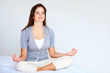 Fototapeten Yoga, meditation and woman with peace in bedroom or spiritual zen in morning from breathing. Calm, lotus and mindfulness exercise in home with person to relax with benefits of self care in mockup © STEEX/peopleimages.com