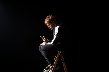 Young man in a sports suit with a smartphone