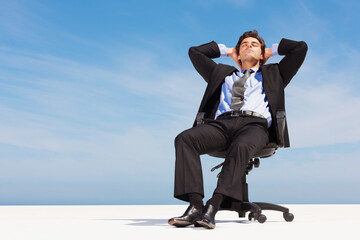 Business man, relax and outdoor sleep of a corporate professional in a chair with peace from calm. Worker, male employee and suit with mockup space and blue sky with job and career with nap sitting