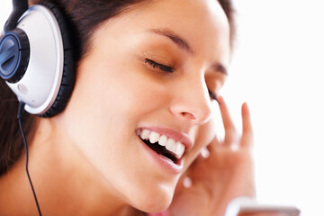 Fototapeta premium Music headphones, singing and woman face listening to playlist track, audio podcast or wellness sound. Freedom, eyes closed and closeup girl, student or singer streaming media, song or radio app
