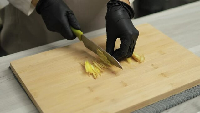 Cook preparing to cook Thai food by cutting white galangal stock video, Homemade cooking concept