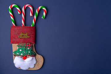 Christmas card on blue background , Christmas sock and Christmas candy. Christmas holiday.