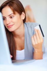 Home, woman and credit card with a laptop, ecommerce and connection with a smile, buying and payment. Person, bedroom or girl with a computer, online shopping and transaction with subscription or app