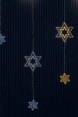 Christmas decorations on a dark background. Shining lights of stars. Abstract colorful background for winter holidays and Christmas.