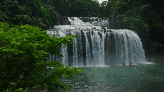 Water stream surrounded by forest. Tinuy-an Falls. Bislig. Surigao del Sur, Philippines.