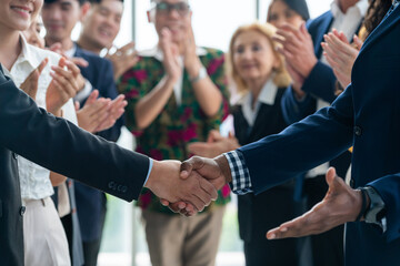Cropped image of businessmen shaking hand and making a contract in the sign of agreement,...