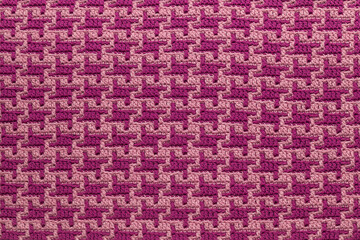 Purple crochet mosaic abstract pattern. Knitted background.
