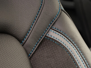 Part of leather car headrest seat details. Сlose-up black and gray   perforated leather car seat....