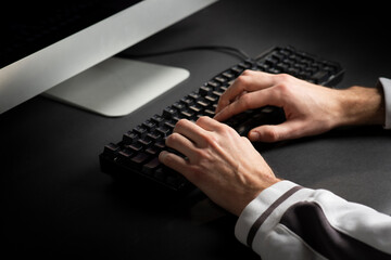 Close-up of typing male hands on keyboard