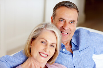 Smile, portrait or senior couple in home with love on sofa to bond or hug in a marriage commitment...