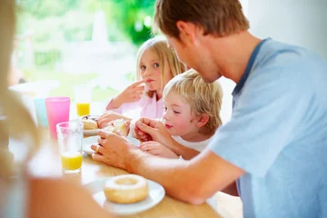 Fotobehang Breakfast, kids and father eating donut at table together, love and bonding in home in the morning. Family, young children and dad with pastry, dessert or junk food sweets for sugar meal in house © STEEX/peopleimages.com