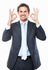 Businessman, ok and smile in portrait, promotion and agreement or approval by white background. Male person, face and emoji or icon, yes and like or success, satisfaction and good job or well done