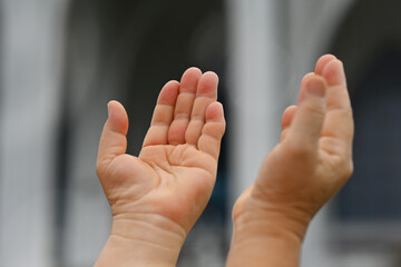Close-up image of woman hands praising with Allah
