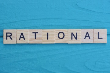 word rational made from wooden gray letters lies on a blue background