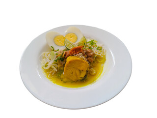 Indonesian chicken soup or soto ayam completed with sliced boiled egg, top view on white plate, isolated on white background