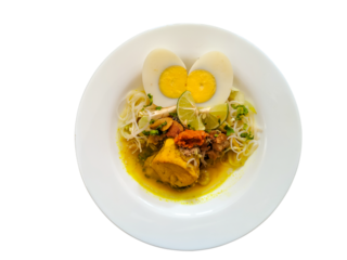 Indonesian chicken soup or soto ayam completed with sliced boiled egg, flat lay on white plate, isolated on white background