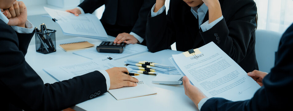 Corporate accountant team use calculator to calculate and maximize tax refunds and improve financial performance based on financial data report. Modern business accounting in panorama. Shrewd