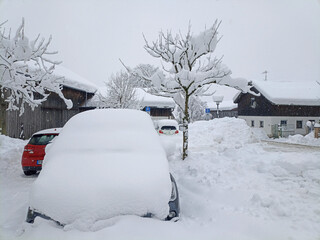 Cars covered with snow in the parking lot near the village supermarket. - 687114267
