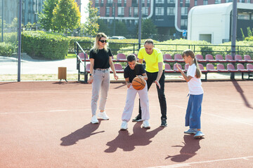 Time for family basketball. Family at basket playground. 