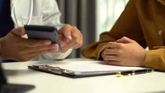 Doctor use a service fee calculator to save money on health insurance, drug cost concepts.