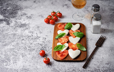 Caprese salad with tomatoes and mozzarella in the shape of hearts for Valentine's Day
