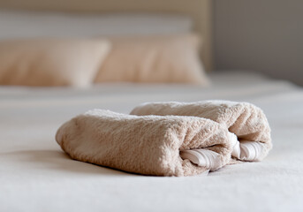 Fototapeta na wymiar towels beige brown color on the bed