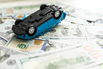 toy, car had accident on dollar banknotes.insurance concept
