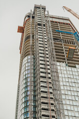 FRANKFURT, GERMANY - July 19, 2023: Construction of a skyscraper apartment block showing upper floors under construction.