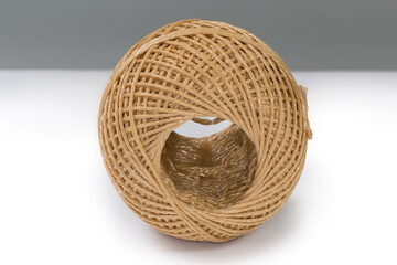 Skein of brown synthetic twine on a white surface