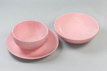 Empty pink bowl on flat plate and other bowl separately