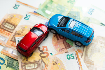Small toy car and money. Loan and finance concepts