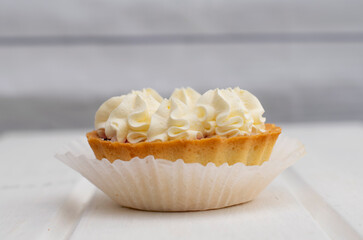 Tart with white cream close-up. Cake on a light background, sweetness, dessert, soft focus.