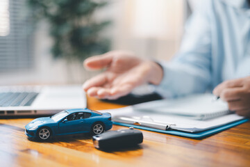 Toy Car In Front Of Businessman Calculating Loan. Saving money for car concept, trade car for cash...