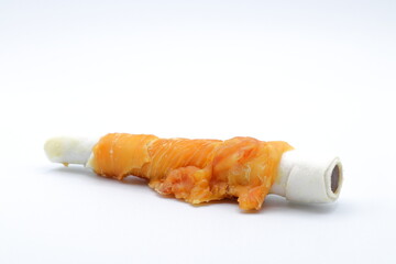 Chew stick dogs. Wrapped in meat. Candy or treat for pets. Close up and isolated.