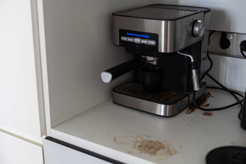 A cup of coffee put on coffee machine making with dirty before cleaning