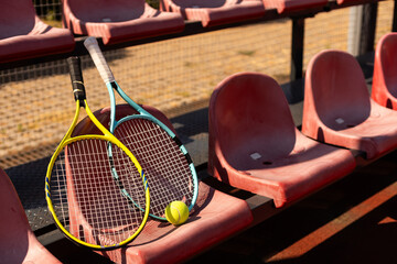 tennis racket with tennis balls on a tennis court