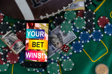 Live in-play betting app on smartphone display, a woman is betting at home and winning, POV shot
