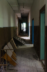 Dark corridor in abandoned building of former House of Culture in resettled village of Pogonnoye in exclusion zone of Chernobyl, Belarus
