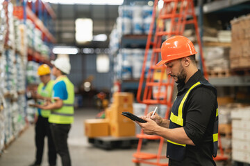 Professional manager man employee using tablet check stock working at warehouse. Worker wearing...