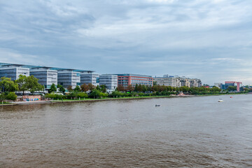 FRANKFURT, GERMANY - July 19 2023: Residential blocks and pedestrian alley on the Main river banks.