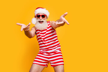Photo of funky cool elderly guy wear new year swimsuit hat sunglass having disco fun choosing you...