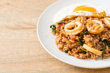 fried rice with squid and basil topped fried egg in Thai style