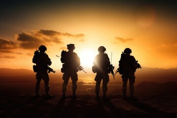 Fototapeta premium A group of soldiers standing on top of a mountain. This image can be used to depict unity, strength, and determination. Suitable for military themes, teamwork, and leadership concepts