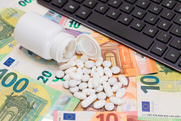 Expensive Medicine and Inflation Concept: Pills and Capsules on the Euro Banknotes. Global Pharmaceutical Industry and Big Pharma. Euro Money Bills