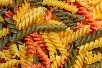 Uncooked Vibrant Colored Fusilli Pasta: A Mesmerizing Culinary Canvas of Multicolored Spirals,...