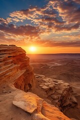 Fototapeta na wymiar A stunning image of the sun setting over a rocky outcropping. Perfect for nature enthusiasts and travel blogs