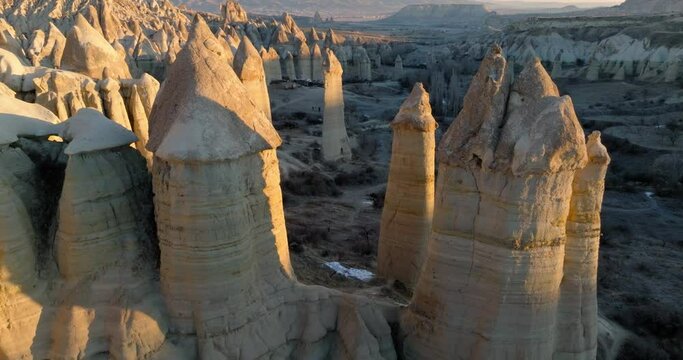 Aerial Forward Descending Shot Of Tall Phallus Shaped Rocks On Natural Landscape At Famous Goreme National Park - Cappadocia, Turkey